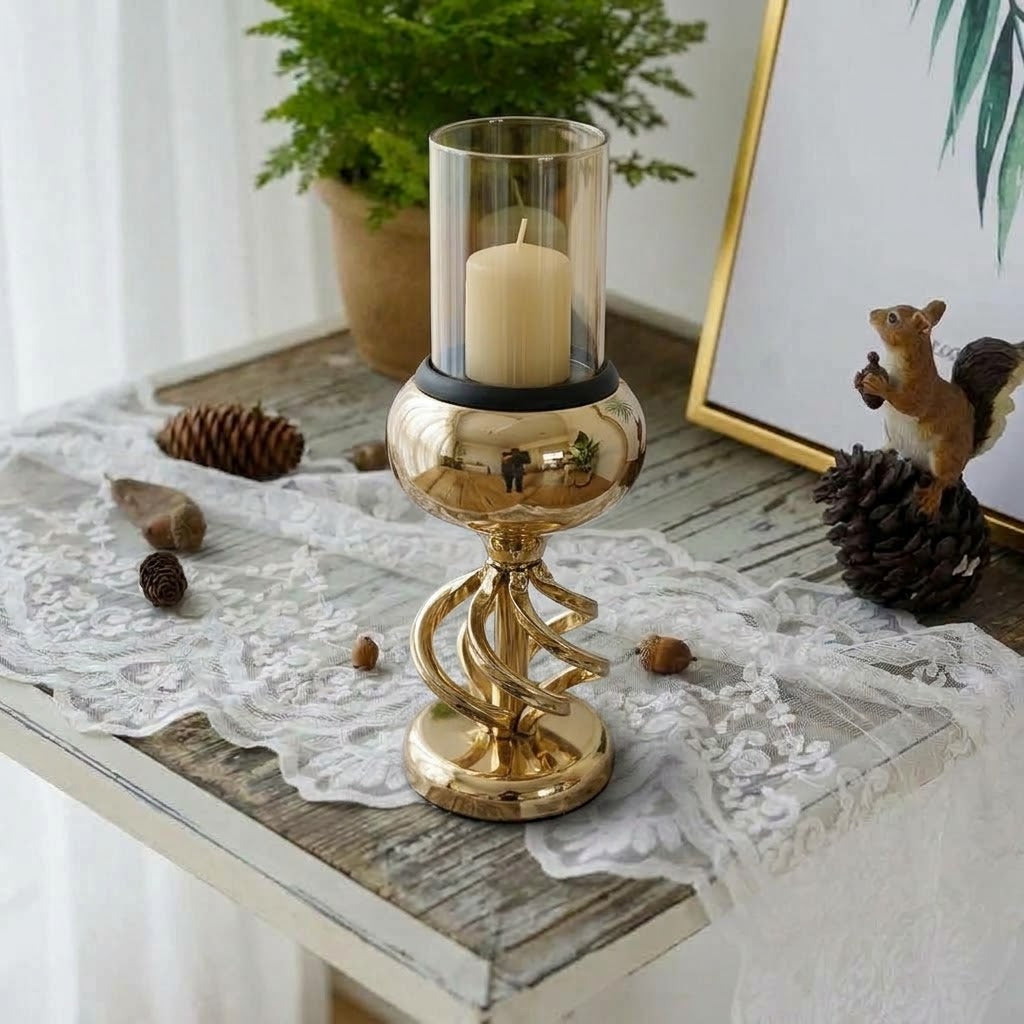 Luxury gold twisted pedestal candle holder with clear glass hurricane shade and burning pillar candle